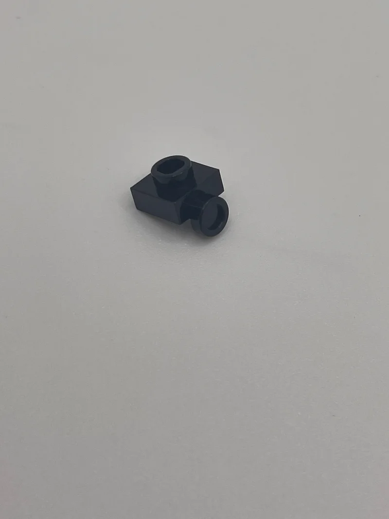 Plate 1 x 1 with one stud on side, descending in Black