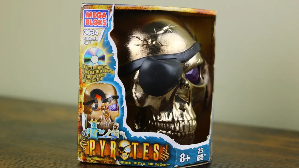 Miscellaneous: themed packaging, bronze skull face w/ black patch