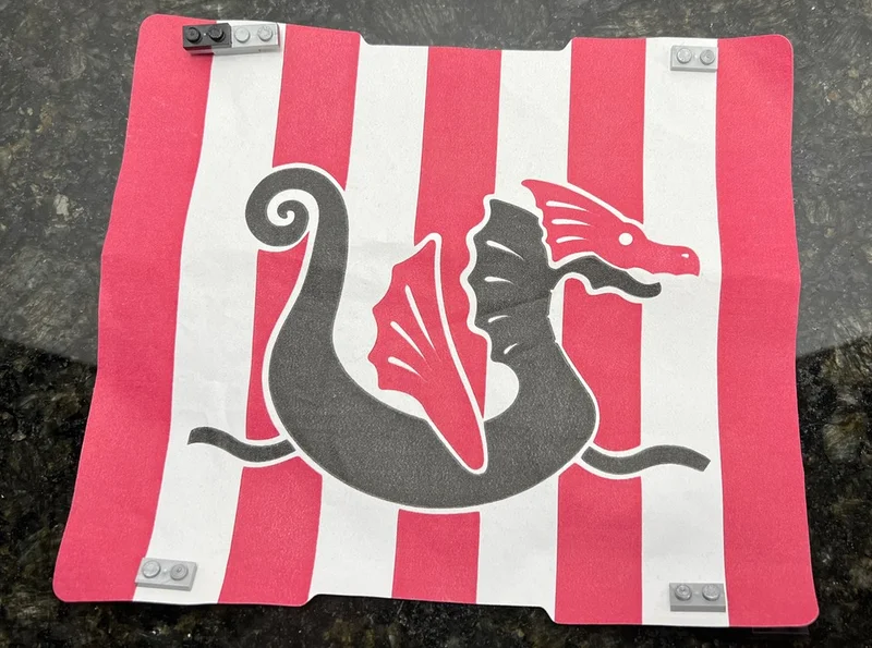 Ship: sail, fabric alternating red & white stripes, dragon emblem in Multicolored