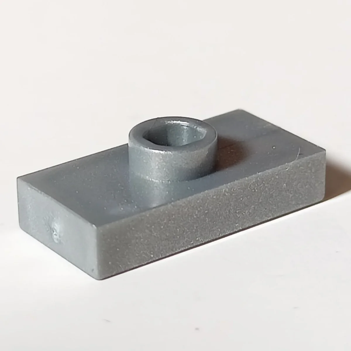 Plate Modified 1 x 2 with one stud, center in Gray, Light