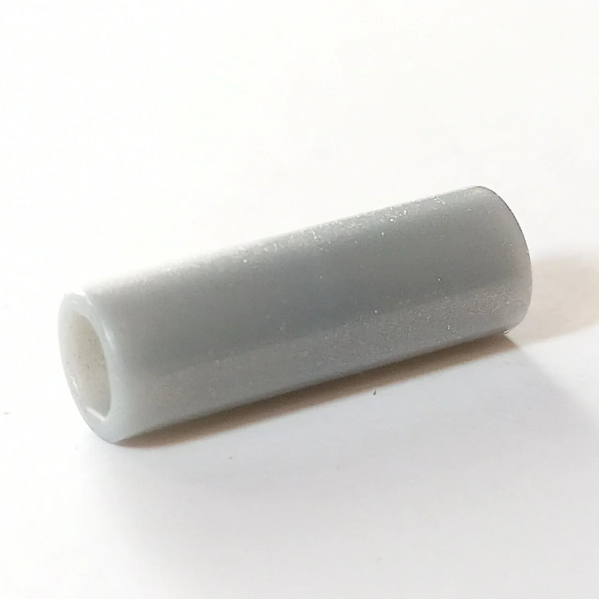 Connector: pipe, small 2 studs long in Gray, Light