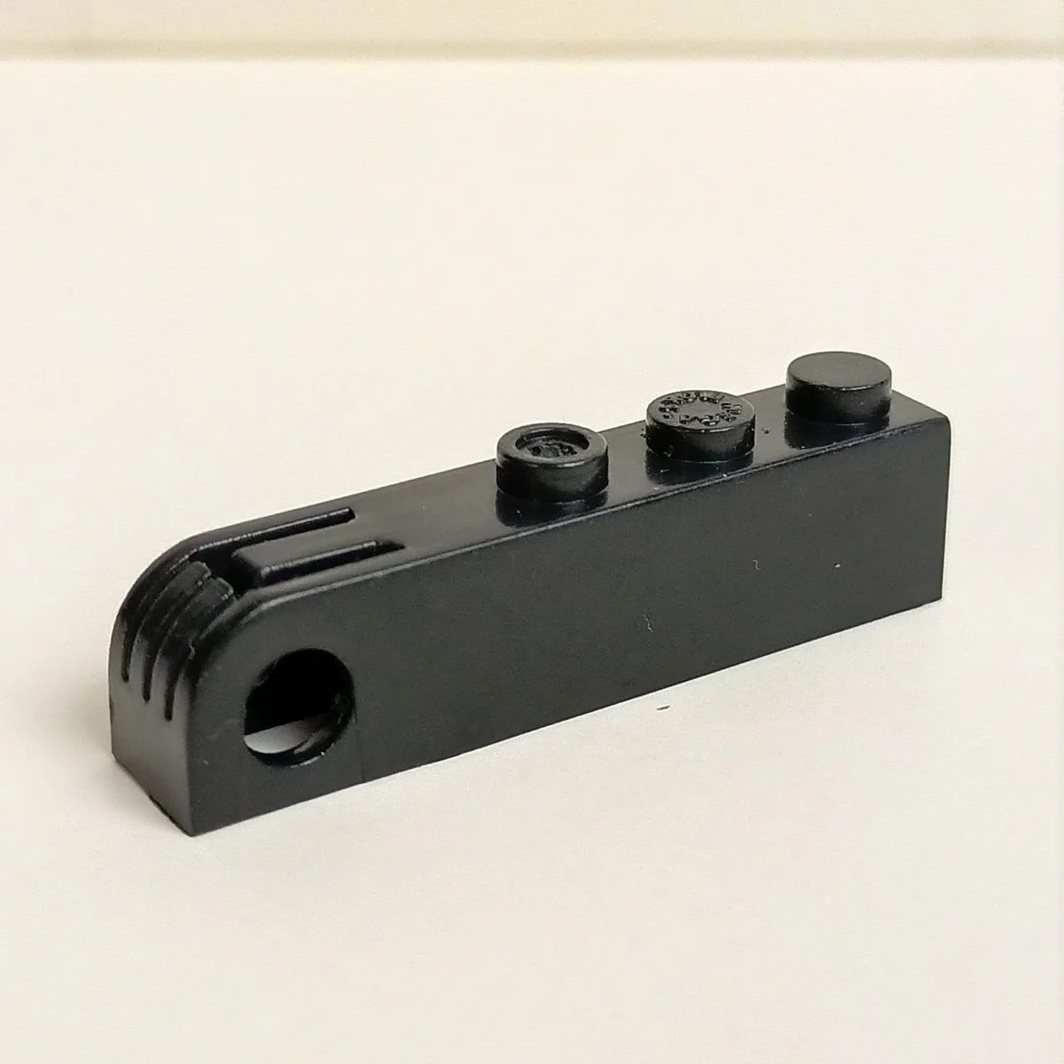 Brick 1 x 5 with rounded end and hole for winch mount in Black