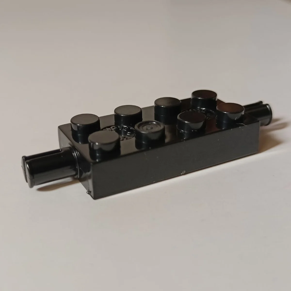 Brick 2 x 4 two-thirds-height with axles in Black