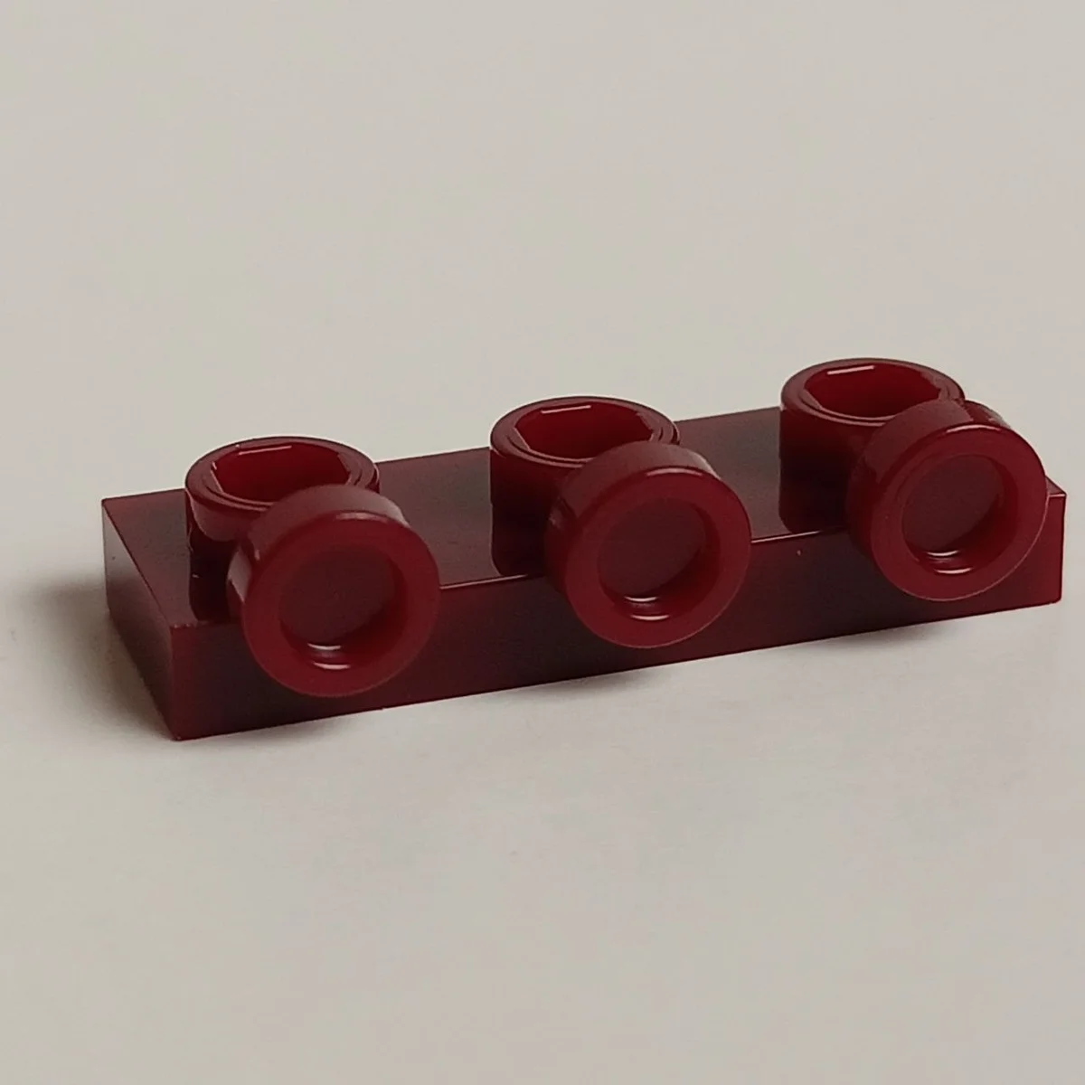 Plate 1 x 3 with three studs on side, ascending in Red, Falu