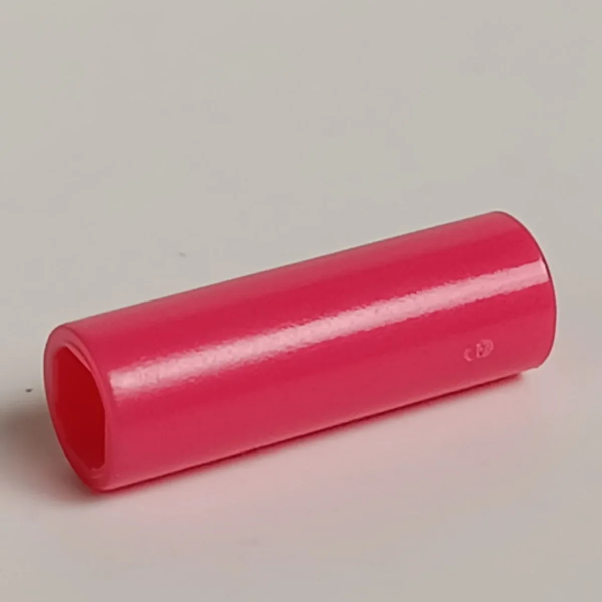 Connector: pipe, small 2 studs long in Pink, Rich