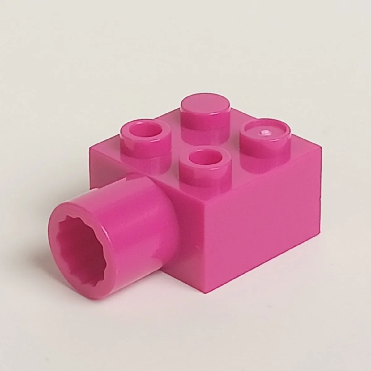 Brick 2 x 2 with protruding axle socket on side in Pink, Barbie