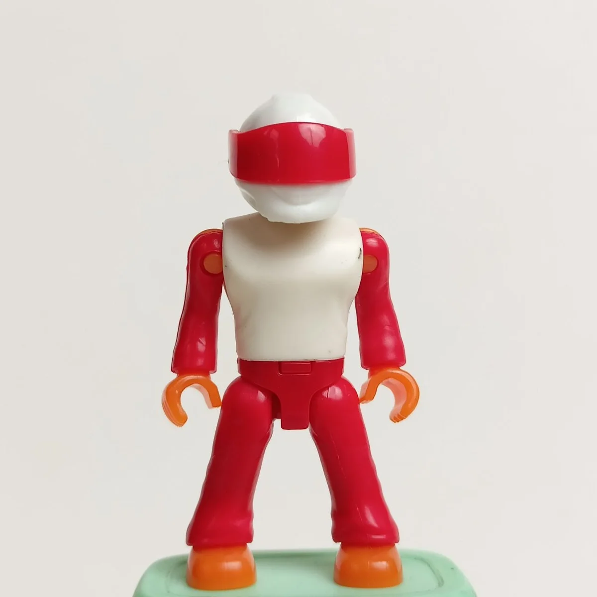 Micro action figure red & white racing uniform, white helmet with solid red visor, orange hands and feet