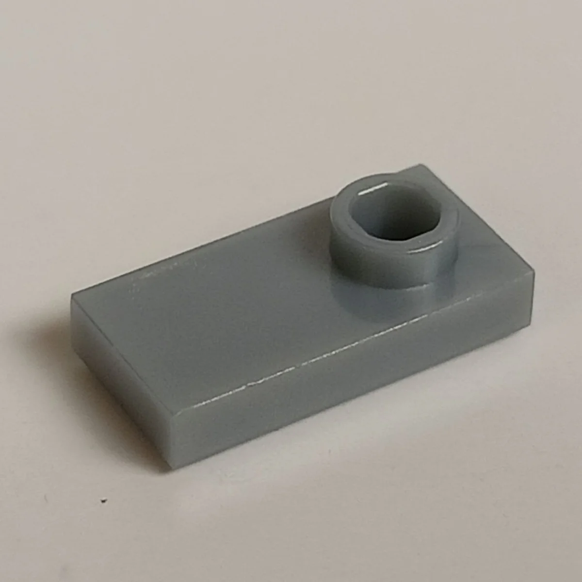 Plate Modified 1 x 2 with one stud, offset in Gray, Steel