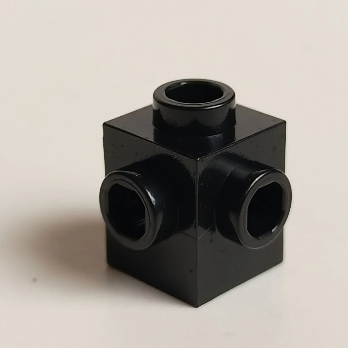 Brick 1 x 1 with studs on adjacent sides in Black