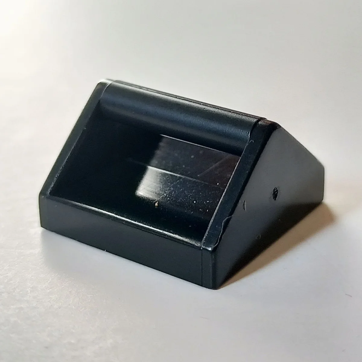 Tile 2 x 2 with raised horizontal bar, type 02 in Black