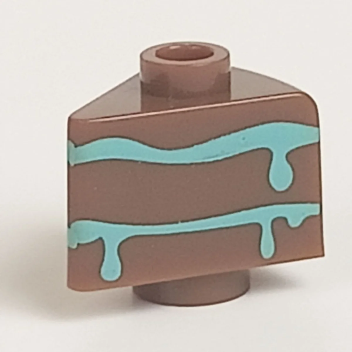 slice of cake with blue frosting pattern in Multicolored