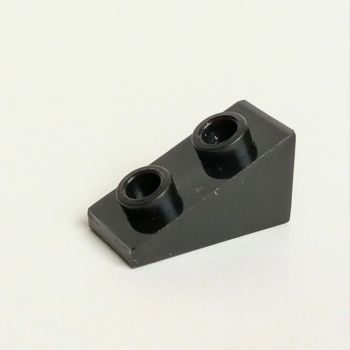 Slope brick 33 1 x 2 with studs on slope in Black