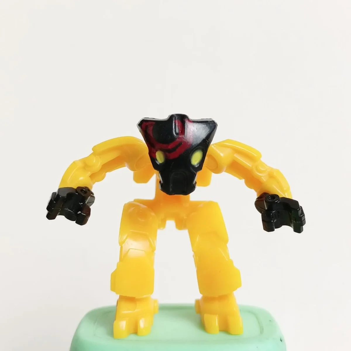 Templar Pal, yellow body, black head and hands with red circle markings and yellow eyes