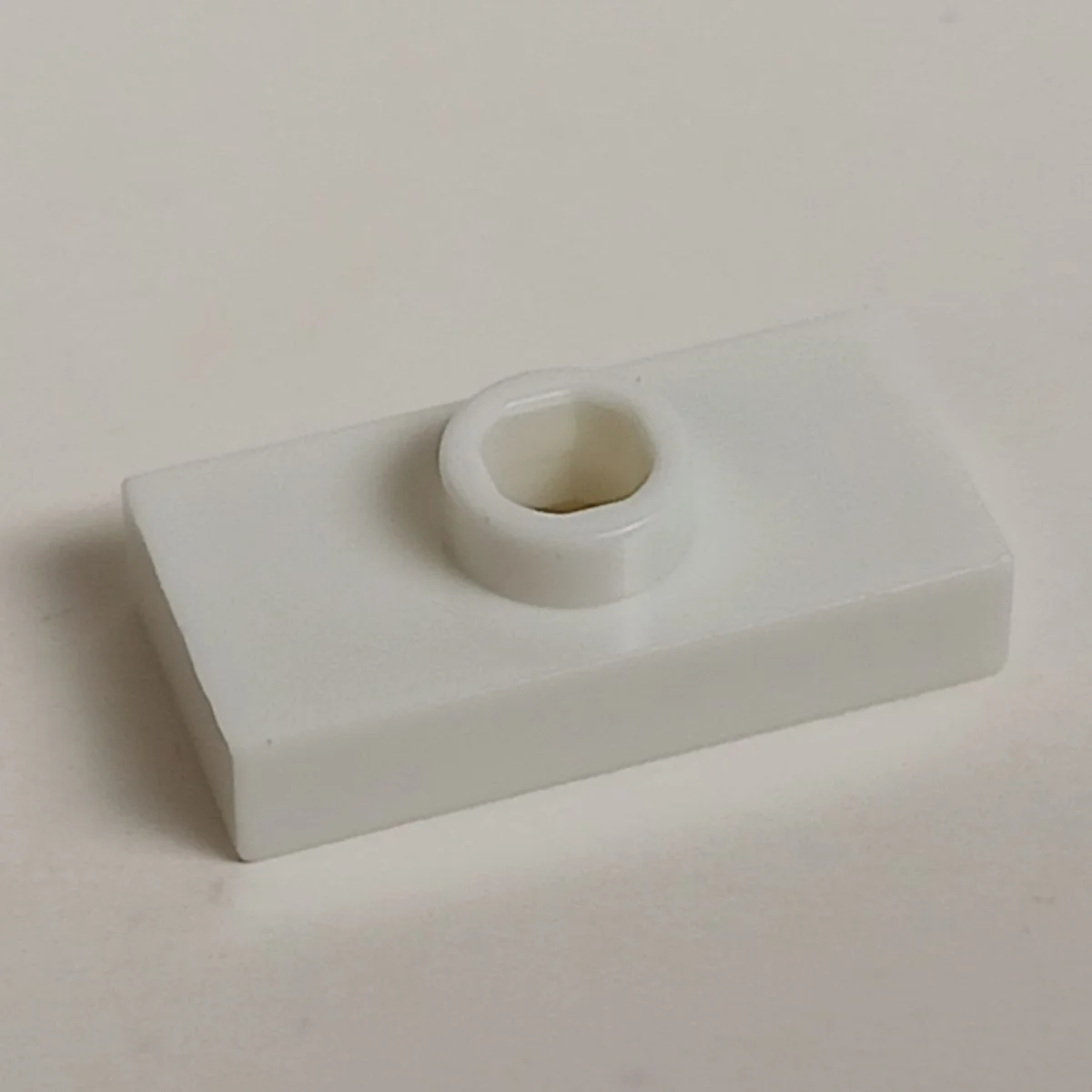 Plate Modified 1 x 2 with one stud, centered in White